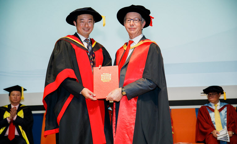 Dr David Cheang receiving his Doctorate in Business